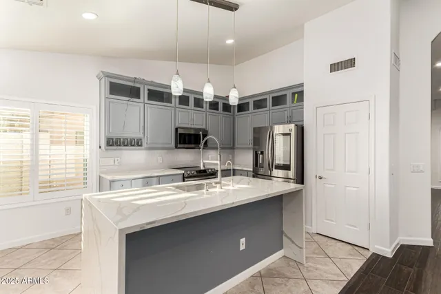 a kitchen with stainless steel appliances granite countertop white cabinets and black stove top oven