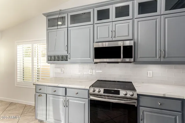 a kitchen with a sink stove and cabinets