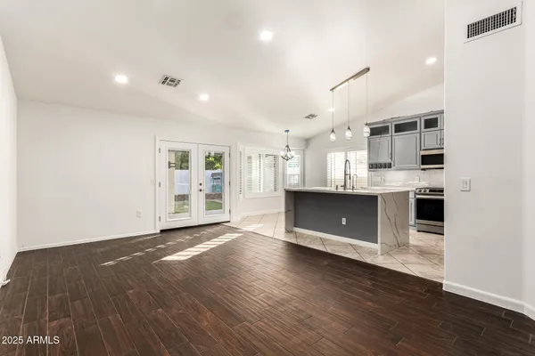 a view of kitchen with kitchen island wooden floor and center island