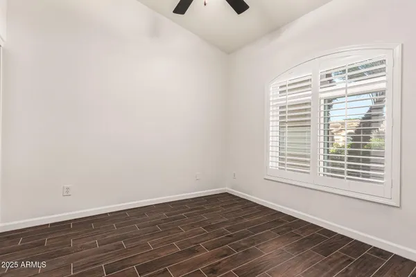 an empty room with wooden floor and closet