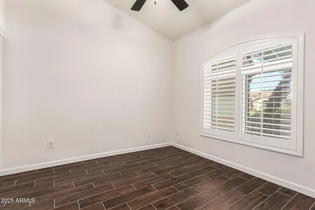 an empty room with wooden floor and closet