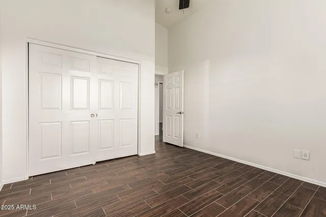 a bathroom with a granite countertop toilet sink mirror and shower