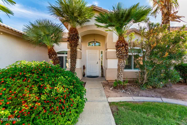 a front view of a house with a garden