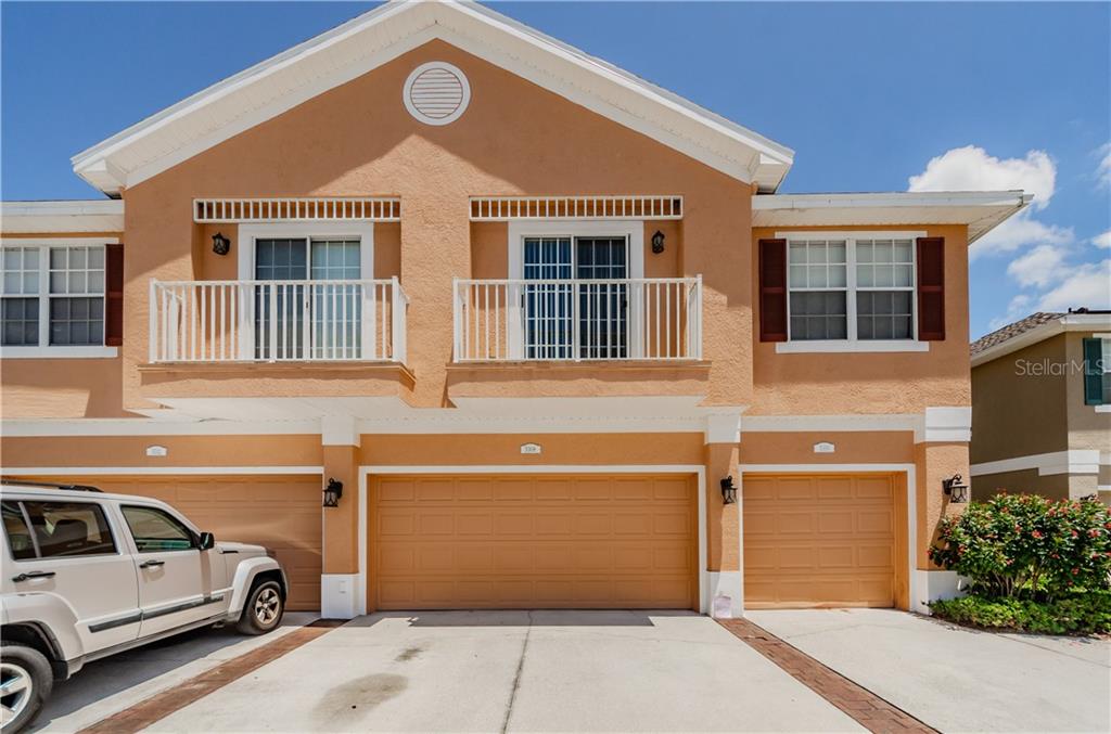 a front view of a house with parking space