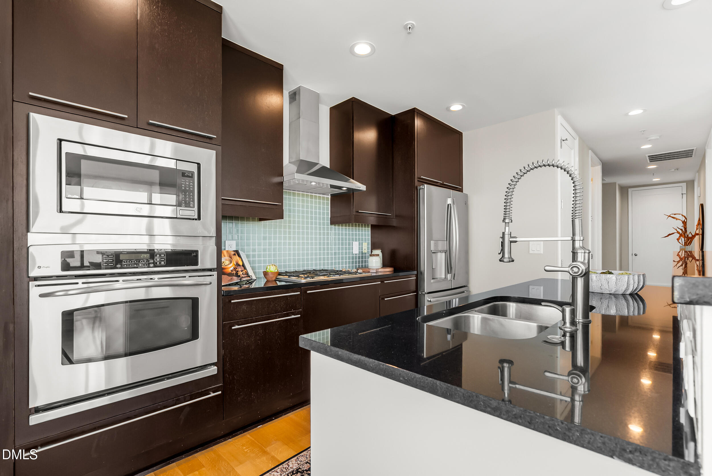 122 North Harrington Street Raleigh, NC 27603 - Photo 12 of 46 a kitchen with stainless steel appliances granite countertop a sink a stove and cabinets