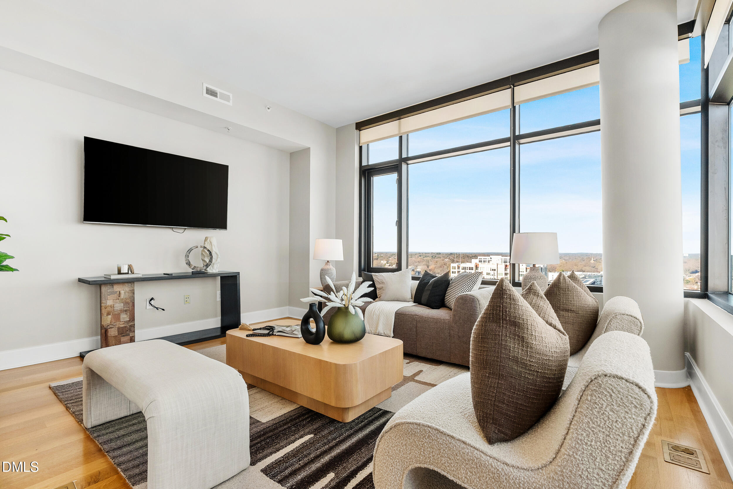 122 North Harrington Street Raleigh, NC 27603 - Photo 6 of 46 a living room with furniture a flat screen tv and a floor to ceiling window