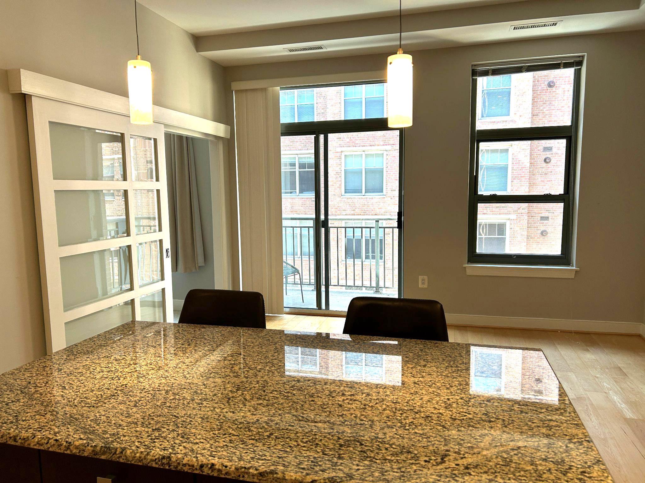2425 L Street Northwest, Unit 421 Washington, DC 20037 - Photo 4 of 18 Kitchen island with seating.