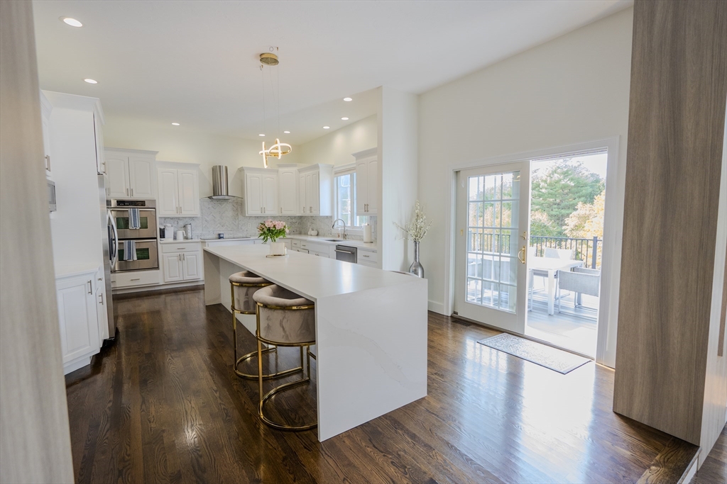 25 Collins Road Berlin, MA 01503 - Photo 12 of 38 a kitchen with kitchen island stainless steel appliances a stove a sink a refrigerator and cabinets