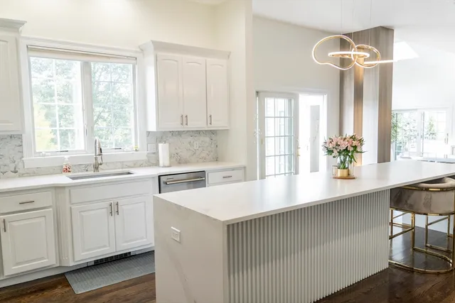 a kitchen with a sink a window and cabinets