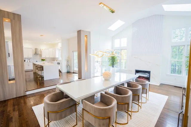 a living room with dining table and wooden floor