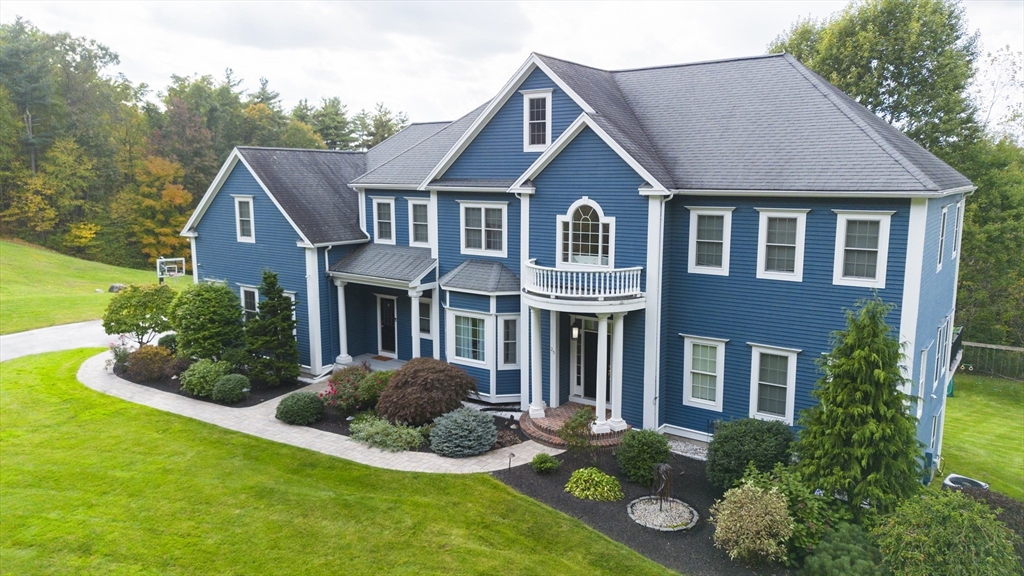 25 Collins Road Berlin, MA 01503 - Photo 2 of 38 a front view of a house with garden and porch