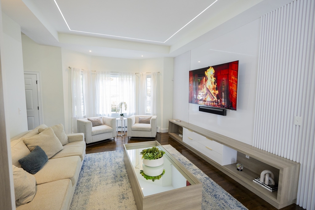 25 Collins Road Berlin, MA 01503 - Photo 23 of 38 a living room with furniture and a flat screen tv
