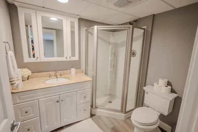 a bathroom with a granite countertop sink toilet and shower