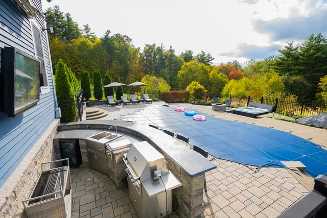a view of a patio with table and chairs with wooden floor and fence