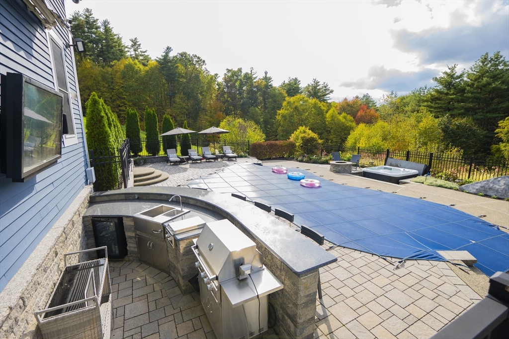 25 Collins Road Berlin, MA 01503 - Photo 6 of 38 a view of a patio with table and chairs with wooden floor and fence