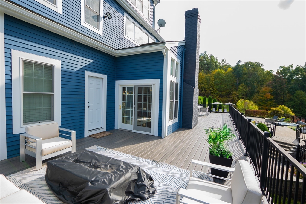 25 Collins Road Berlin, MA 01503 - Photo 8 of 38 a view of a patio with couches table and chairs and potted plants