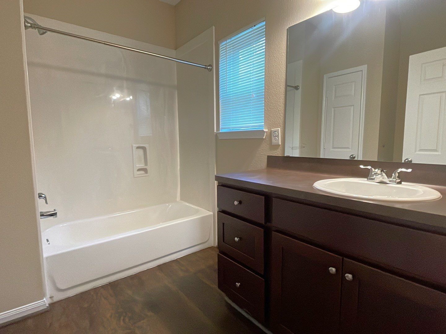8138 Gallahad Street, Unit A Houston, TX 77078 - Photo 17 of 26 a bathroom with a tub sink double vanity and a mirror