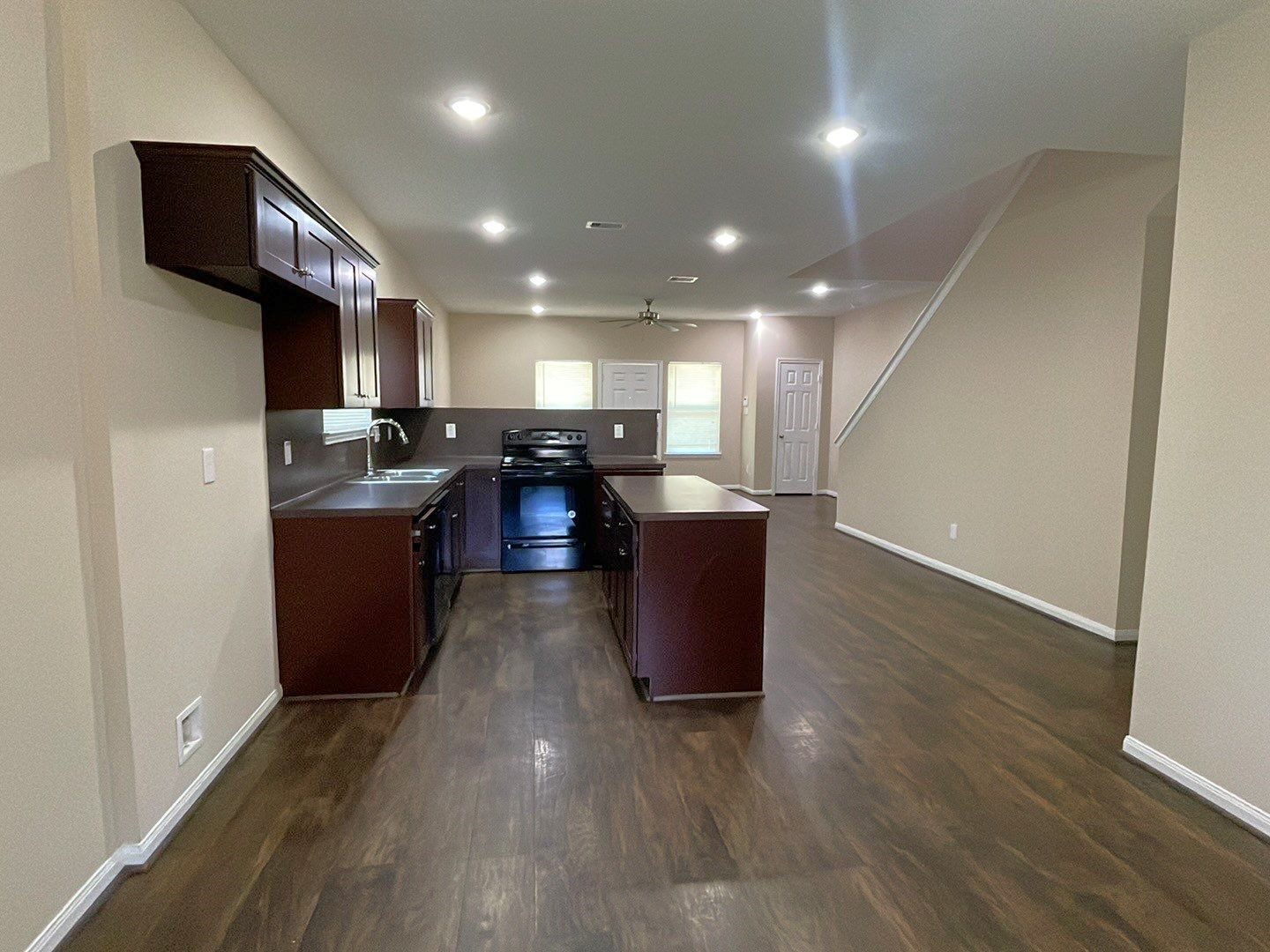 8138 Gallahad Street, Unit A Houston, TX 77078 - Photo 5 of 26 a open kitchen with stainless steel appliances granite countertop a refrigerator a sink dishwasher a stove and a dining table with wooden floor