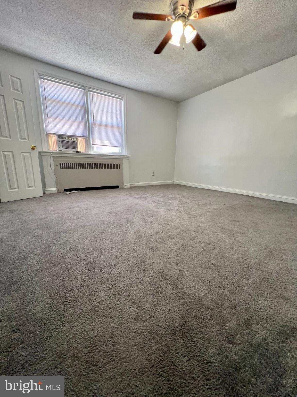 624 Briarcliff Road, Unit MAIN Upper Darby, PA 19082 - Photo 11 of 20 an empty room with chandelier fan and windows
