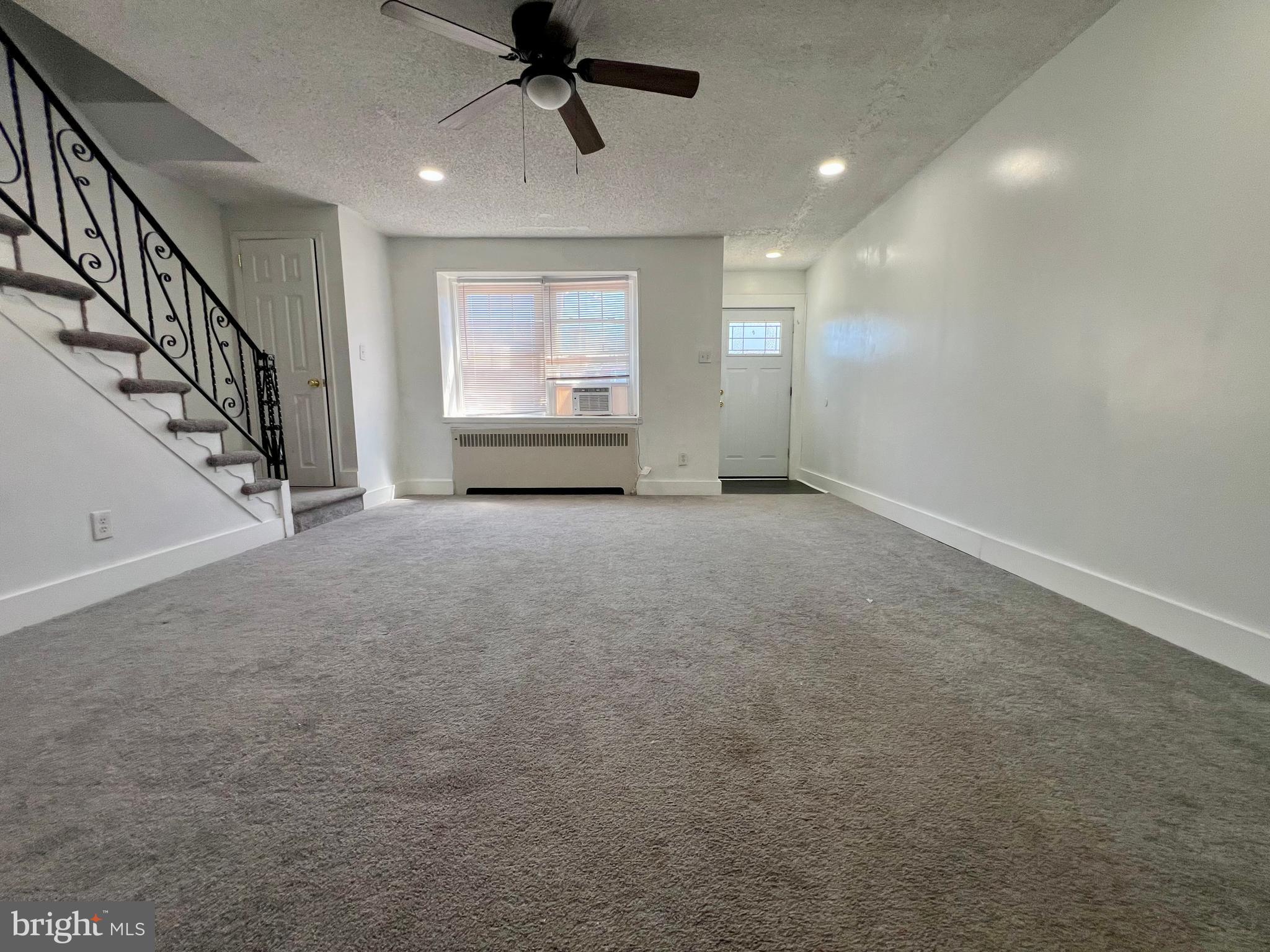 624 Briarcliff Road, Unit MAIN Upper Darby, PA 19082 - Photo 6 of 20 a view of empty room with wooden floor and fan