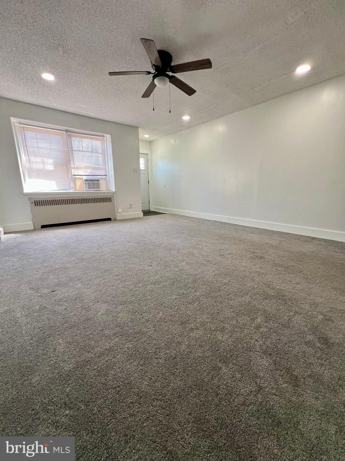 624 Briarcliff Road, Unit MAIN Upper Darby, PA 19082 - Photo 7 of 20 an empty room with windows and fan