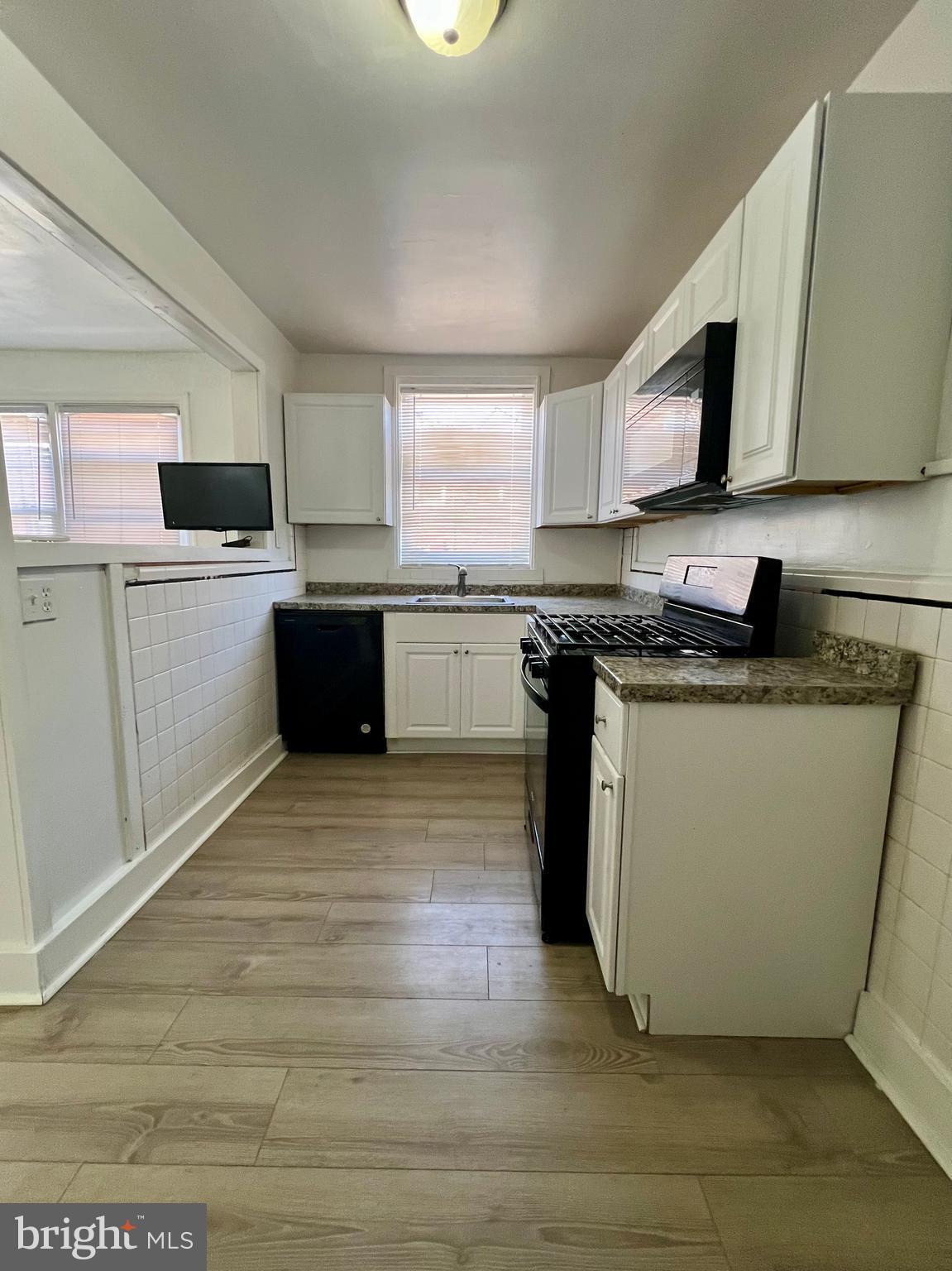 624 Briarcliff Road, Unit MAIN Upper Darby, PA 19082 - Photo 9 of 20 a kitchen with a sink stove top oven and cabinets