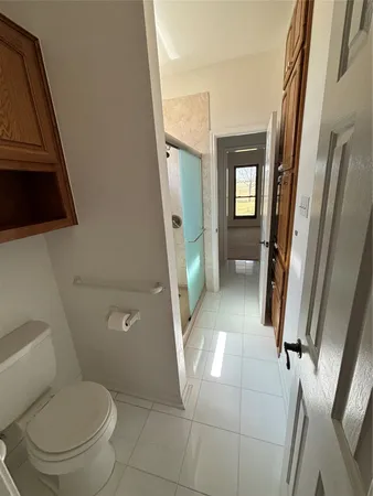 a bathroom with a toilet and a shower