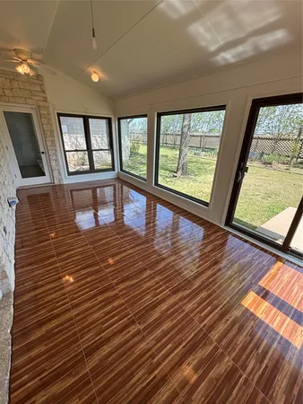 a view of a room with wooden floor and large windows