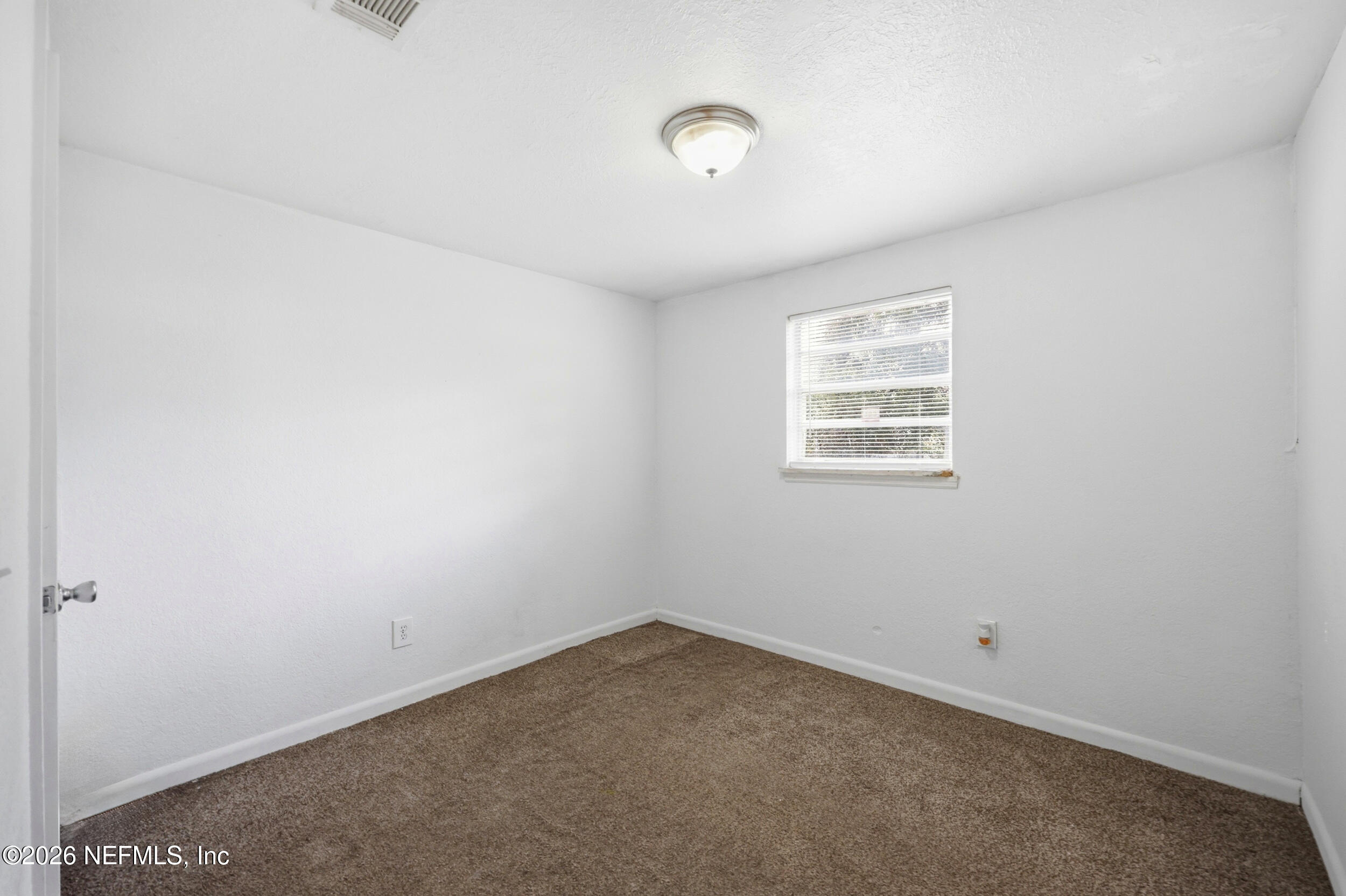 9843 Wagner Road Jacksonville, FL 32219 - Photo 13 of 40 an empty room with a window