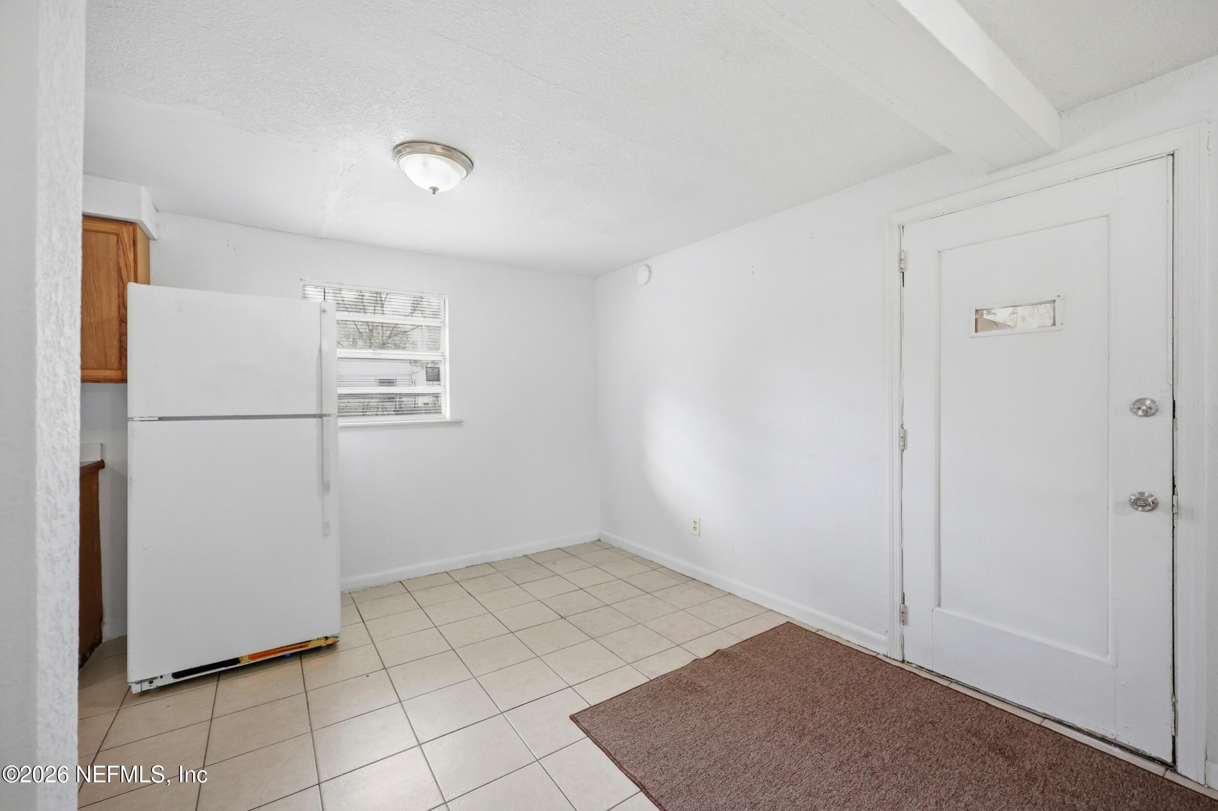9843 Wagner Road Jacksonville, FL 32219 - Photo 7 of 40 a view of a refrigerator in kitchen and white cabinets