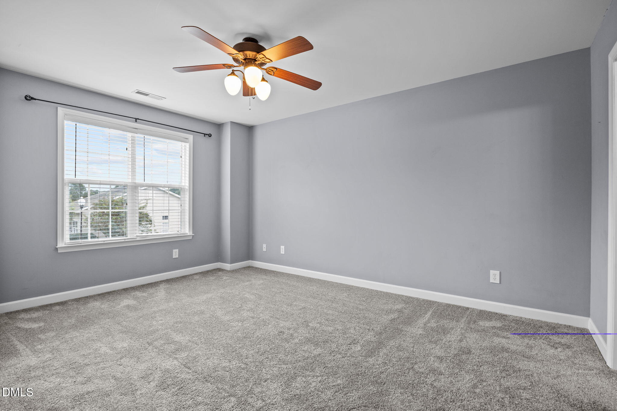4522 Centrebrook Circle Raleigh, NC 27616 - Photo 10 of 24 an empty room with a window and a fan