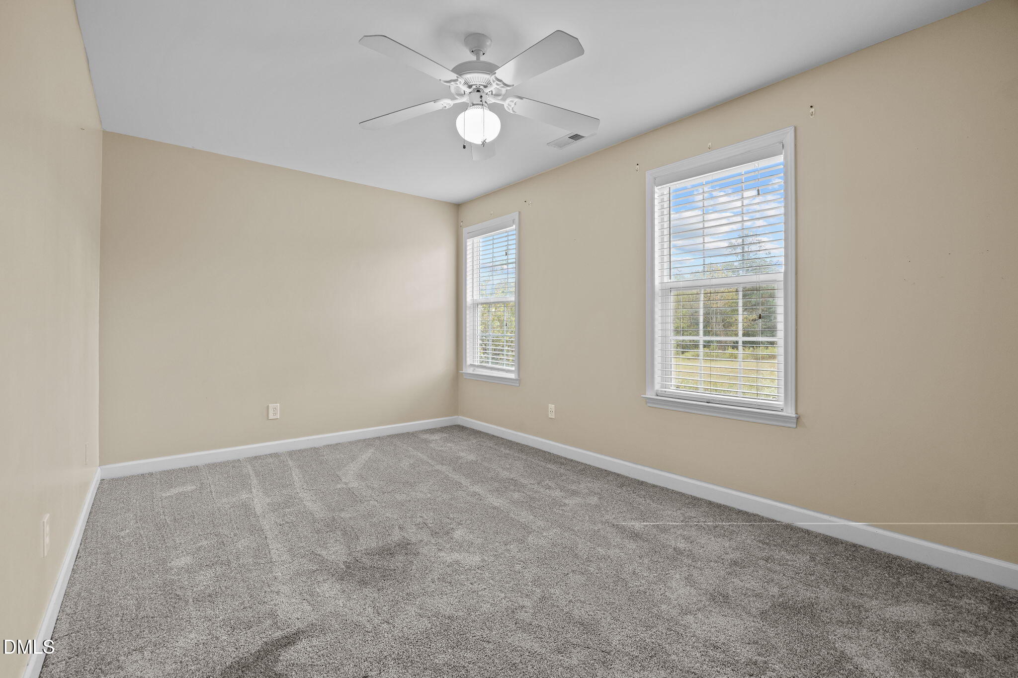 4522 Centrebrook Circle Raleigh, NC 27616 - Photo 13 of 24 an empty room with windows and ceiling fan