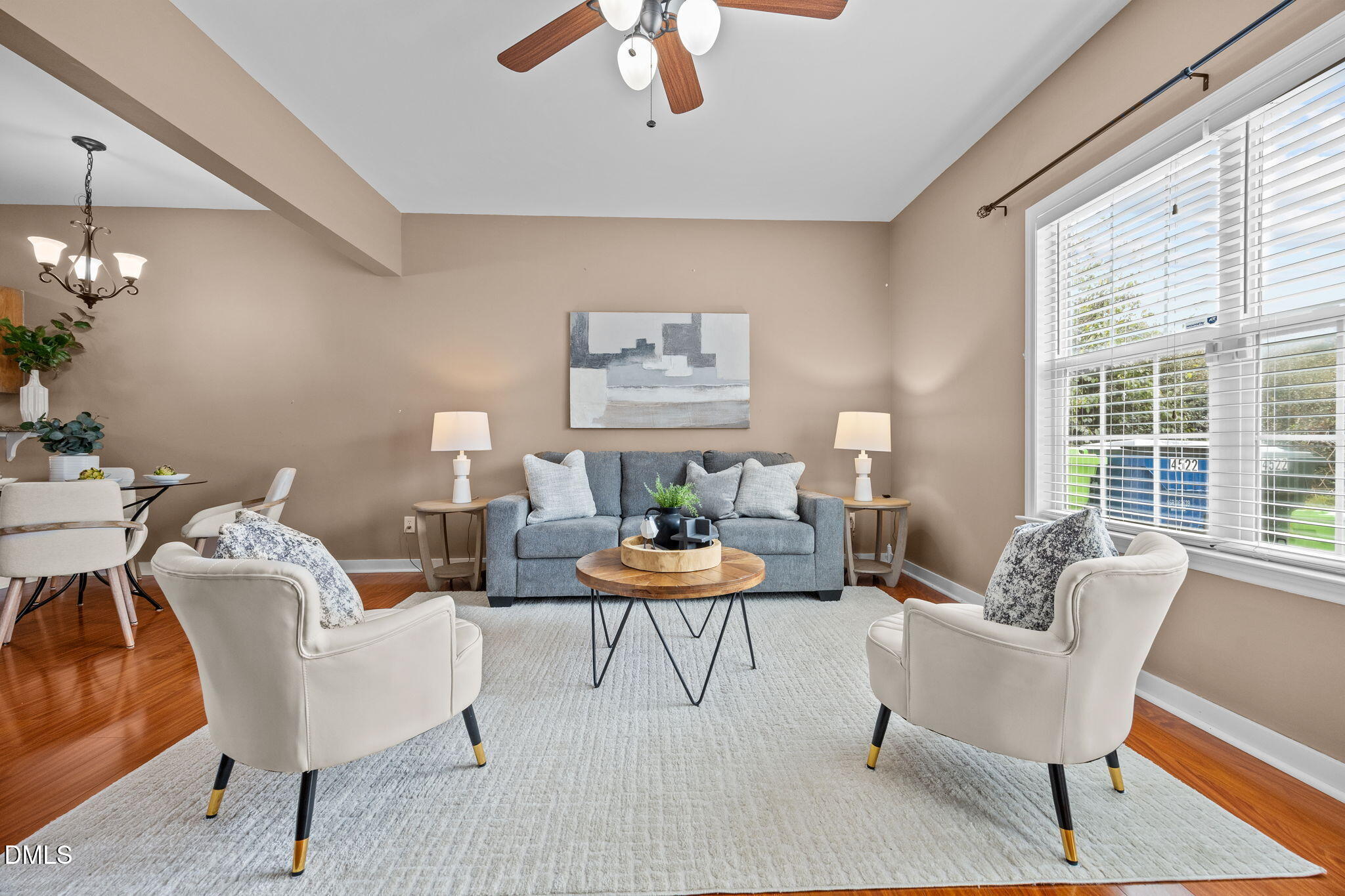 4522 Centrebrook Circle Raleigh, NC 27616 - Photo 3 of 24 a living room with furniture a chandelier and a large window