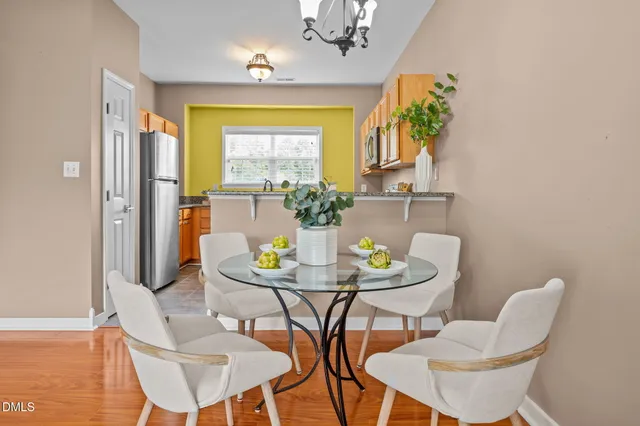 a living room with furniture a chandelier and a large window