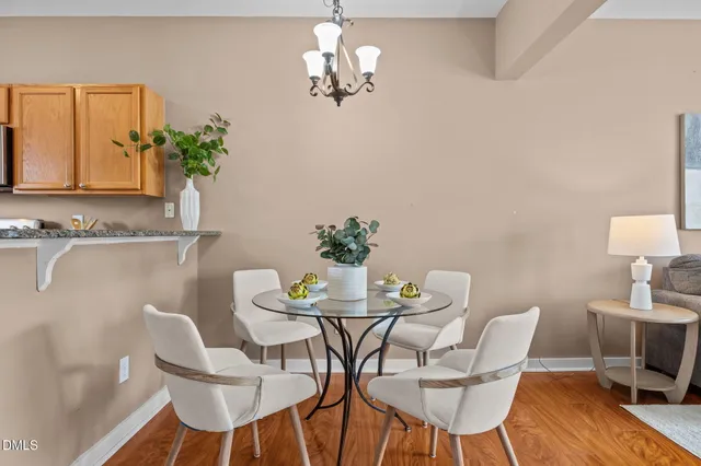 a view of a dining room with furniture and chandelier