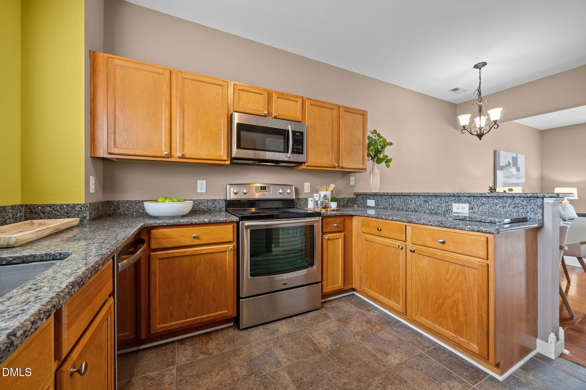 4522 Centrebrook Circle Raleigh, NC 27616 - Photo 8 of 24 a kitchen with stainless steel appliances granite countertop a sink stove and microwave