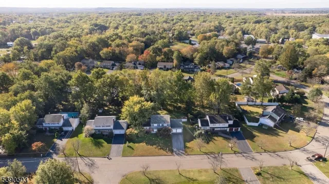 an aerial view of a houses with a swimming pool