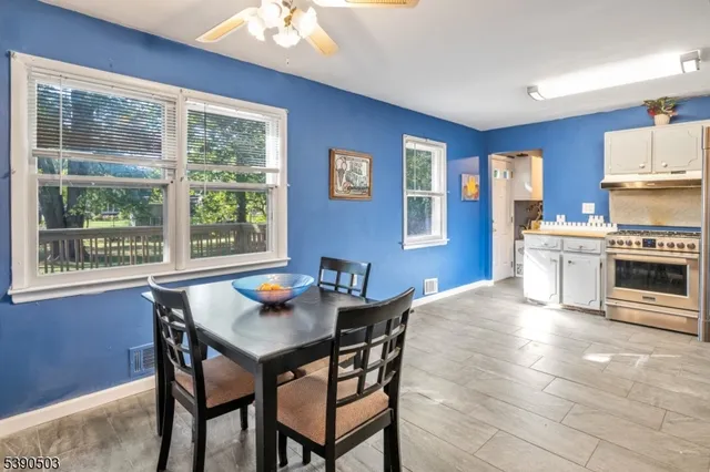 a kitchen with a stove a table and chairs in it