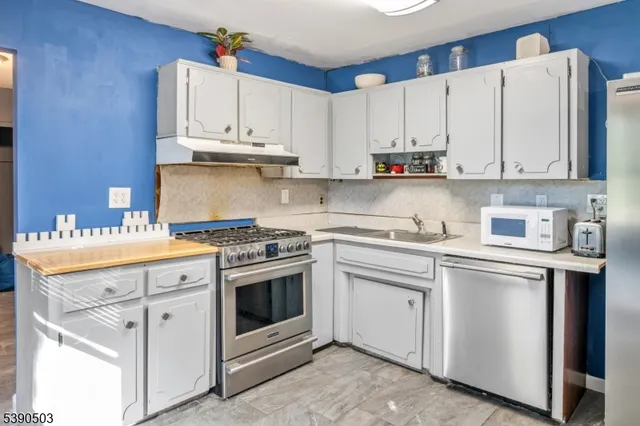 a kitchen with stainless steel appliances granite countertop a sink and cabinets