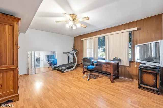 a view of a livingroom with workspace and a window