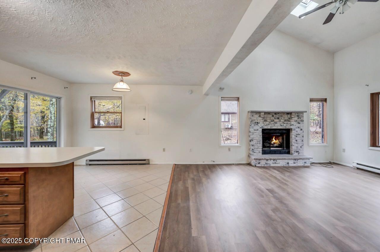 38 Spokane Road Albrightsville, PA 18210 - Photo 12 of 69 an empty room with windows and a fireplace