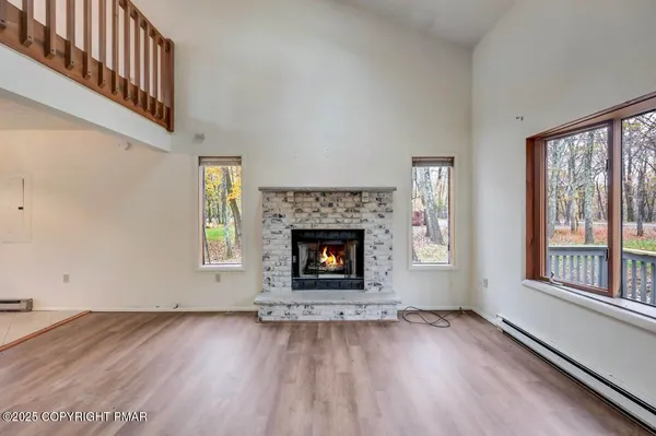 a kitchen with stainless steel appliances granite countertop a refrigerator a sink a stove top oven and a large window