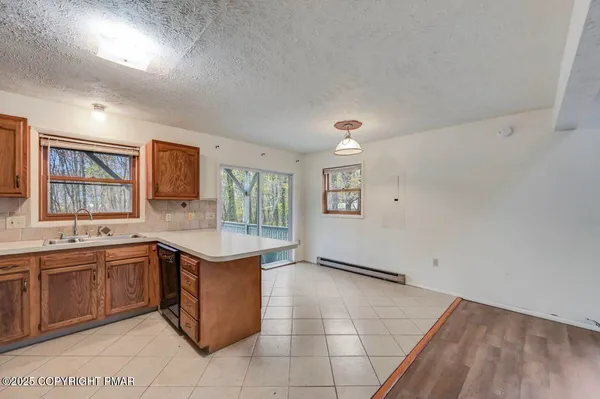 a kitchen with stainless steel appliances a stove a sink a refrigerator and cabinets