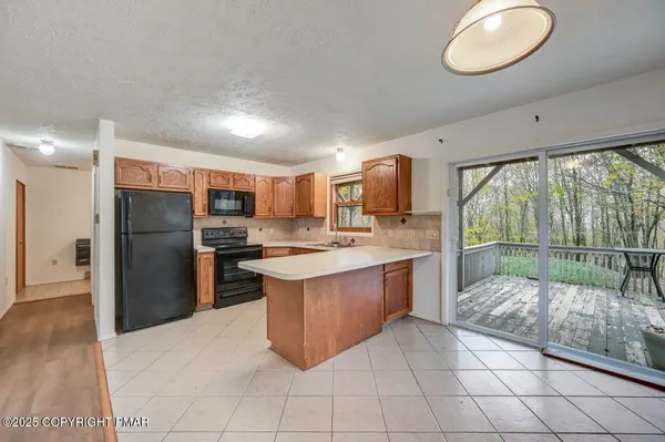 a large white kitchen with a large window