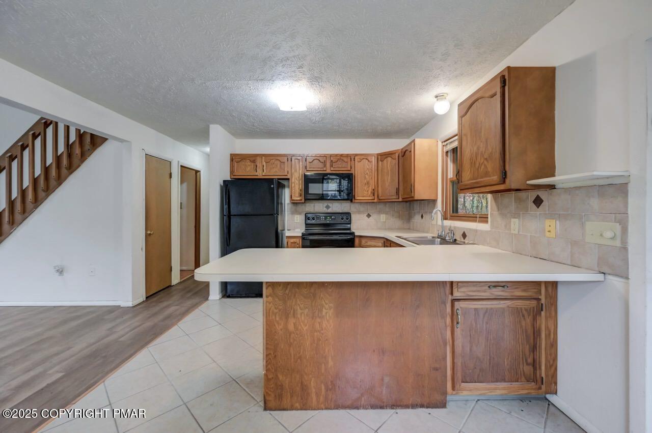 38 Spokane Road Albrightsville, PA 18210 - Photo 19 of 69 a kitchen with stainless steel appliances a stove a sink a refrigerator and cabinets
