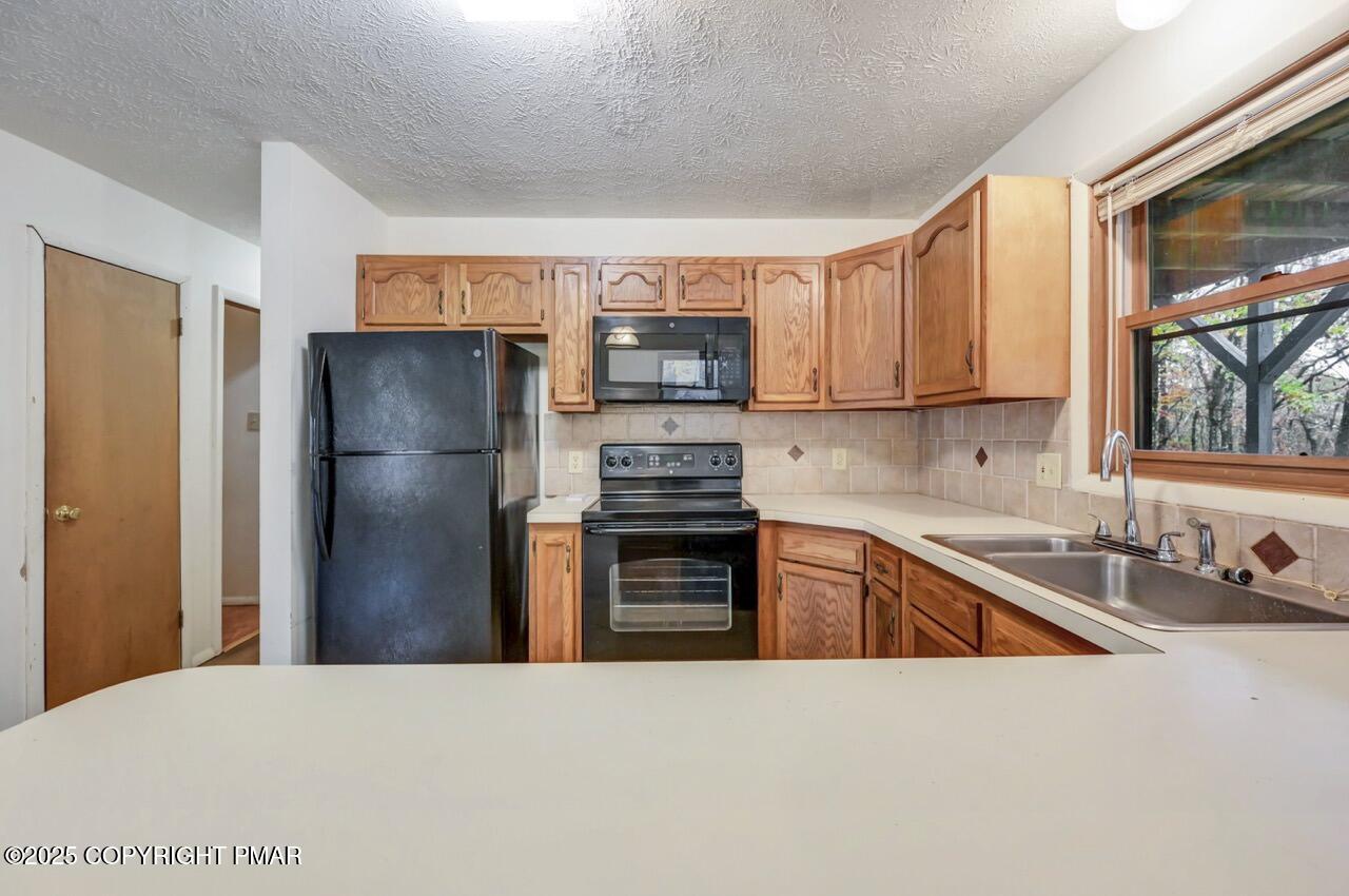 38 Spokane Road Albrightsville, PA 18210 - Photo 20 of 69 a kitchen with a refrigerator and a sink