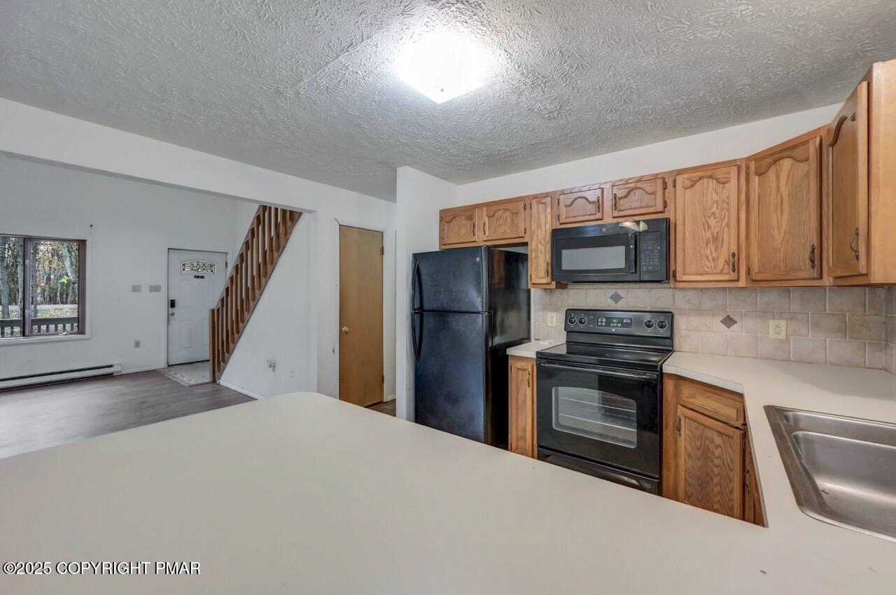 38 Spokane Road Albrightsville, PA 18210 - Photo 21 of 69 a kitchen with stainless steel appliances granite countertop a refrigerator stove and sink