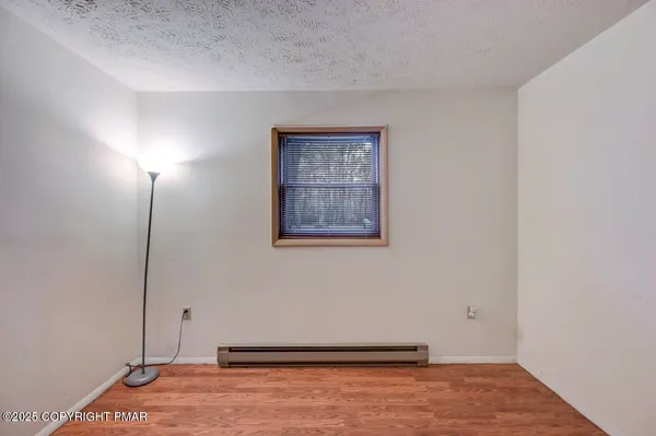 a view of an entryway with wooden floor and a fireplace