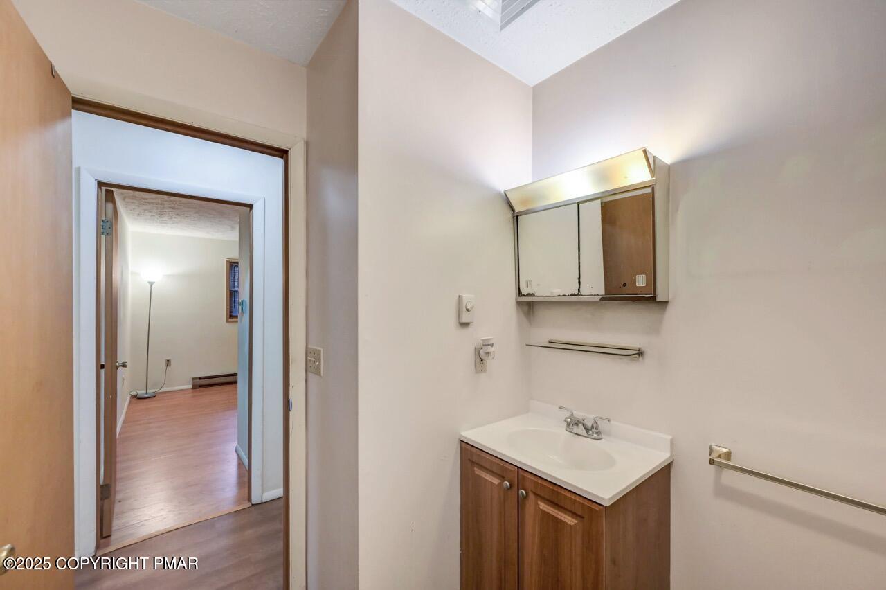 38 Spokane Road Albrightsville, PA 18210 - Photo 33 of 69 a bathroom with a sink a mirror and a toilet