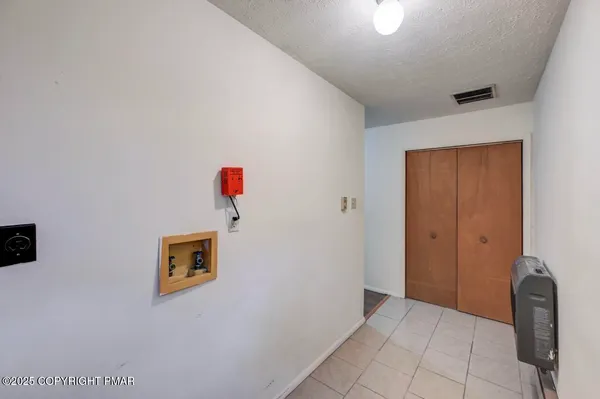 a view of a room with wooden floor and a window